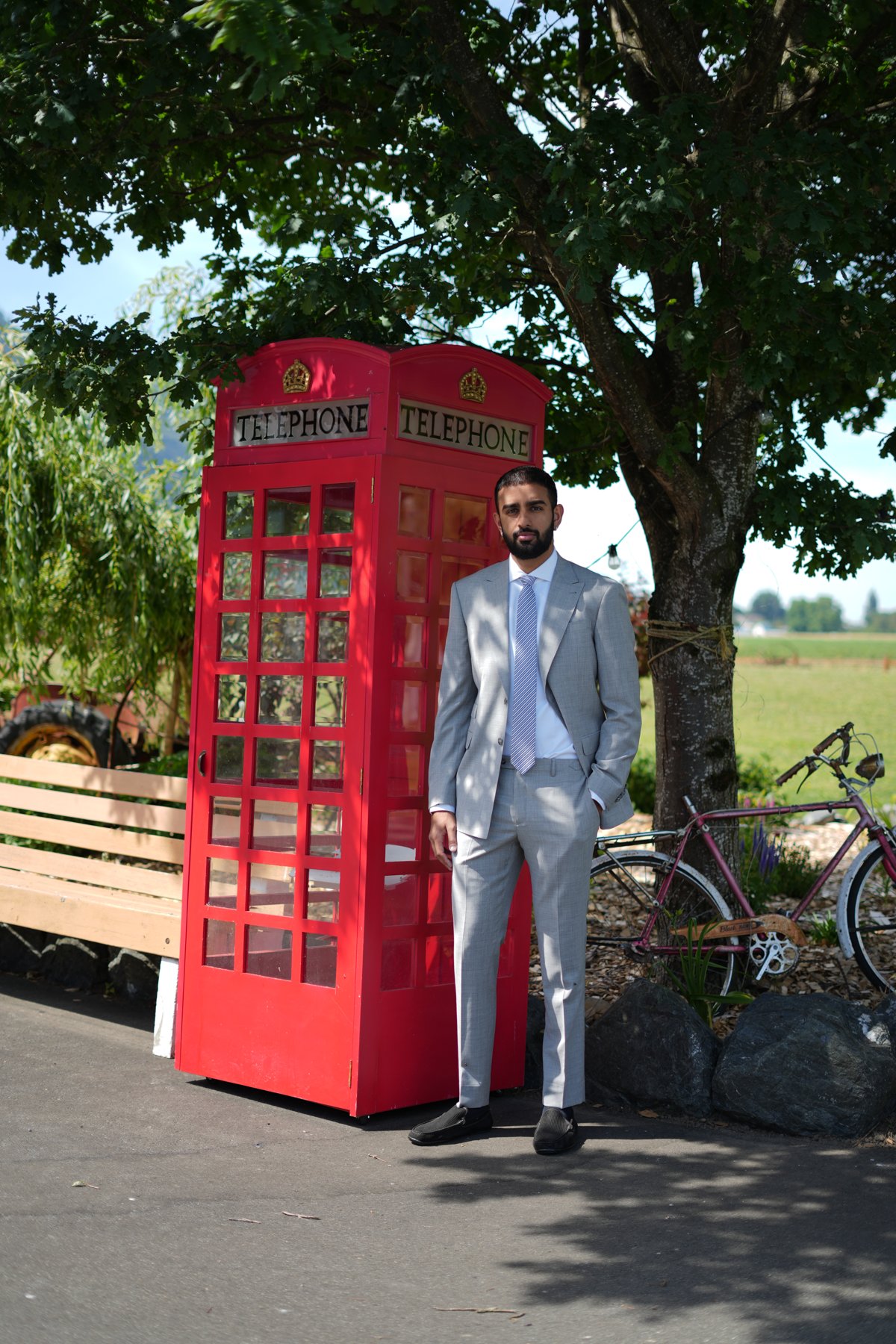 Light grey bespoke suit beside a red telephone box — Suited Booted & Co. editorial