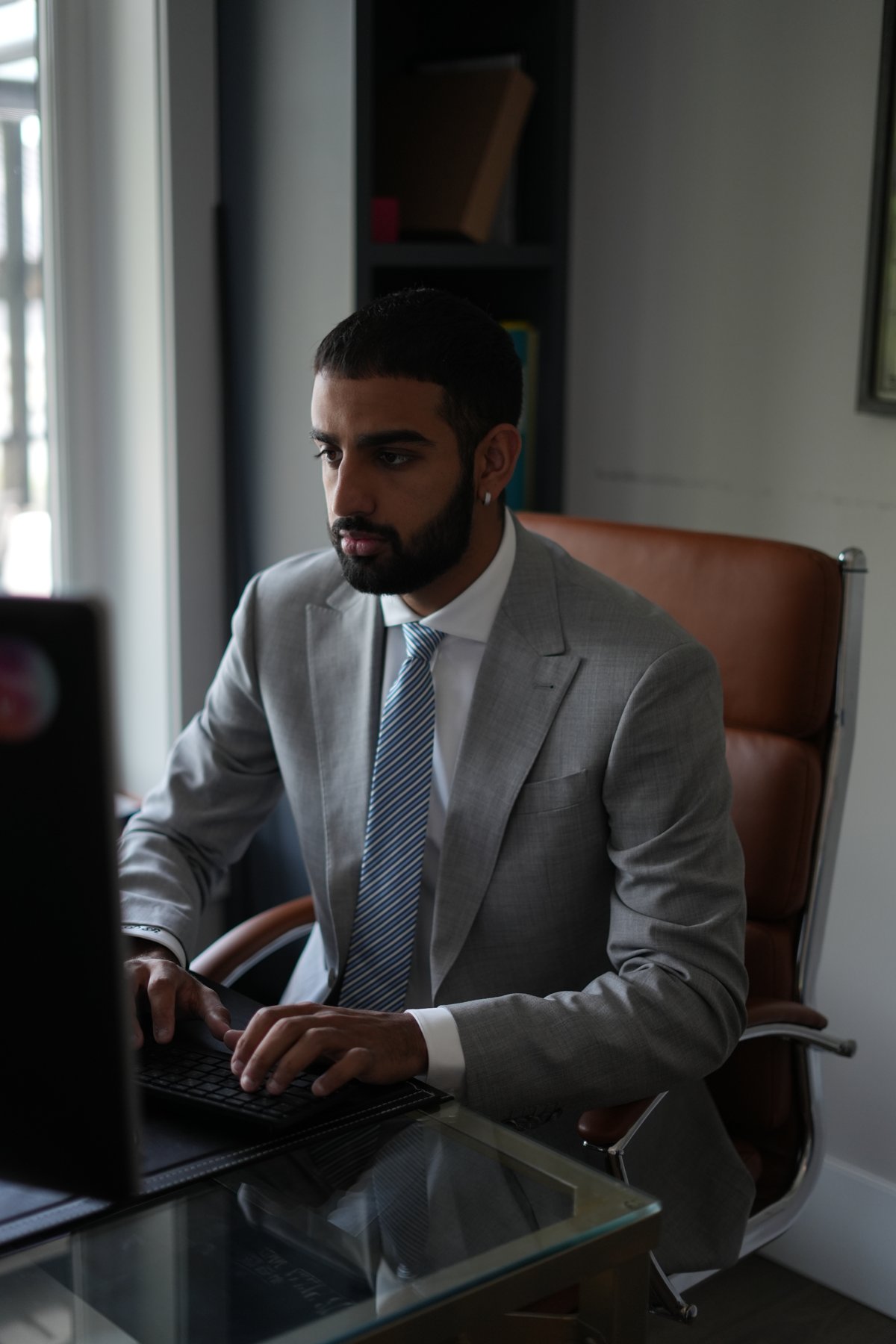 Grey bespoke suit at the executive desk — workwear tailored by Suited Booted & Co.